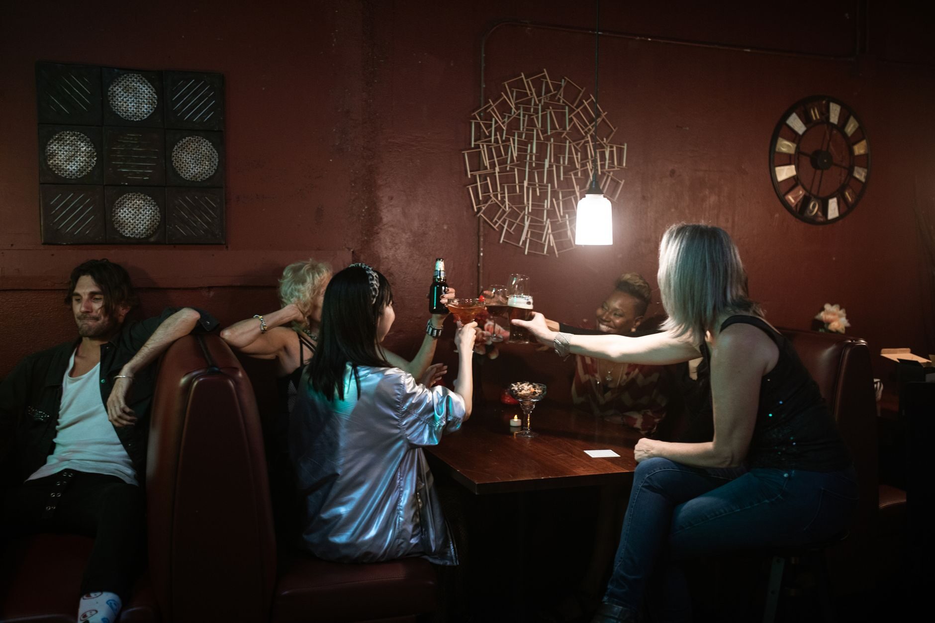 A group raising a toast around a table at the end of a long night